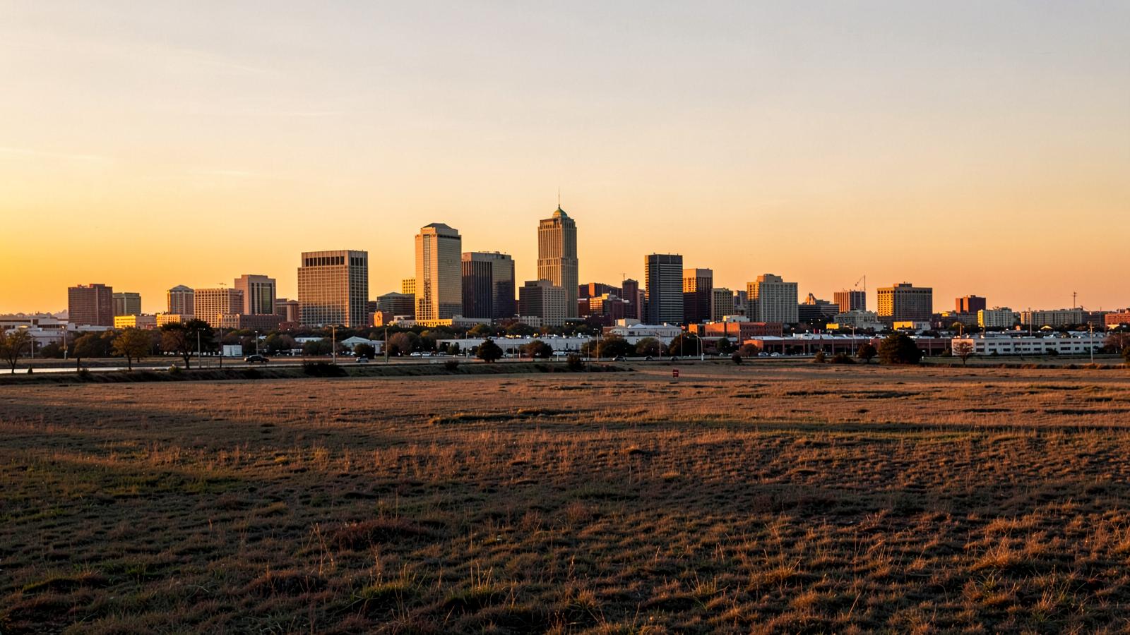The downtown Fort Worth skyline at golden hour beyond open prairie