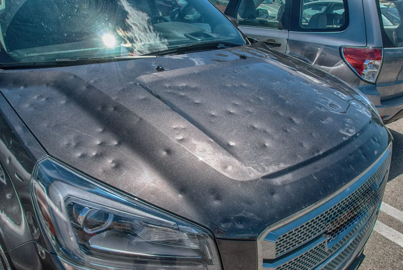 Hail damaged vehicle with dents across hood for paintless dent repair insurance claim in the Dallas-Fort Worth metroplex