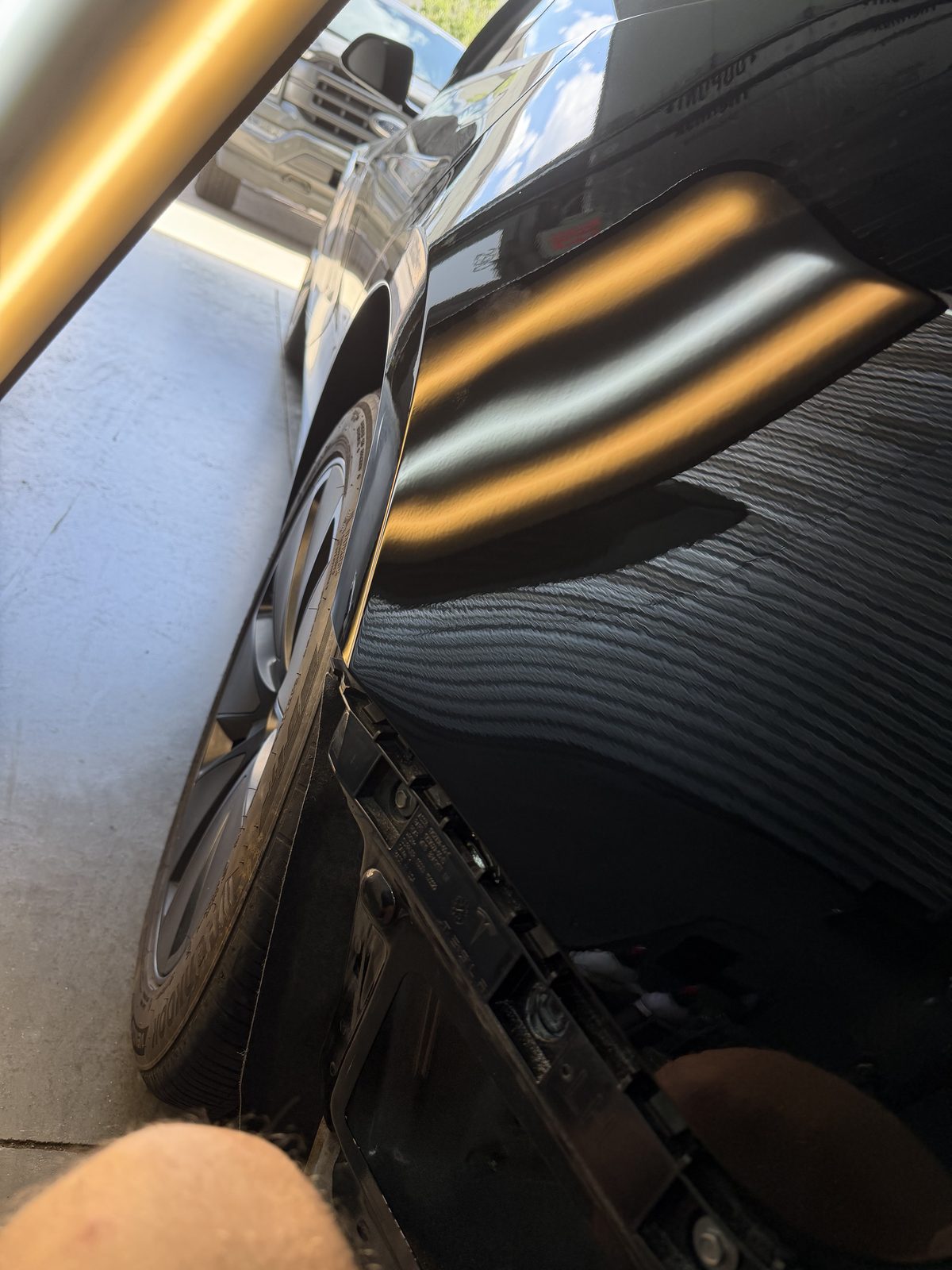 Reflection board revealing dents across a dark painted panel